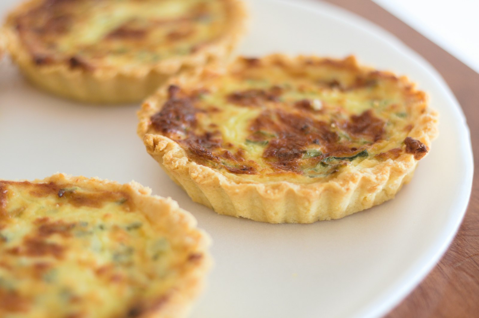 A quiche, served — the plate before the mind is fed
